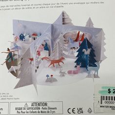 an origami christmas scene is shown in the box with instructions on how to make it