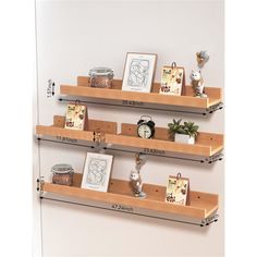 three wooden shelves with pictures and other items on them