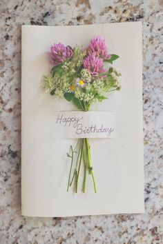 a happy birthday card with flowers on it