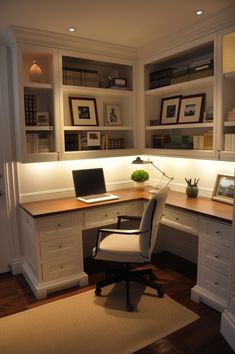 a home office with built - in shelving and desk