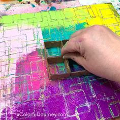 a person is using a stamp to paint squares