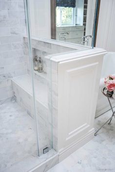 a bath room with a stand up shower