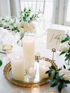 a table with candles and flowers on it