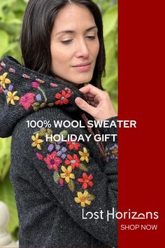 a woman wearing a sweater with flowers on it and the words, 100 % wool sweaterer holiday gift