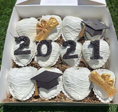 graduation cupcakes in a box decorated with gold and black decorations for the class of 2012