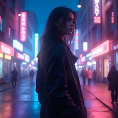 a woman standing in the middle of a city street at night with neon signs on buildings