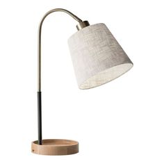 From the round naturalwood catch-all base to the handy device-charging USB port, the Granada lamp is a multitasking masterpiece. It features a textured off-white fabric shade, black fabric-covered cord and antique brass and black accents for mixed-material appeal. Emitting a bright glow, this innovative piece is perfect for small tabletops and spaces with limited outlets. Lamp With Usb Port, Stylish Table Lamps, Transitional Table Lamps, Table Top Lamps, Task Lamp, Metal Desks, Task Lamps, Brass Table, Metal Table Lamps