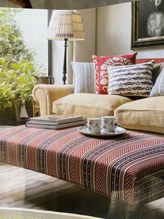 a living room filled with furniture and pillows