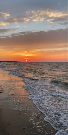 the sun is setting over the water at the beach