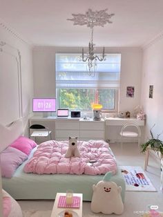 there is a bed with pink sheets and stuffed animals on the bottom, and a chandelier hanging from the ceiling