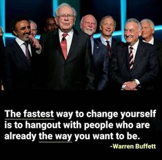 a group of men standing next to each other in front of a quote from warren buffett