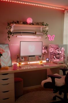 a computer desk topped with a monitor next to a pink light filled wall and chair