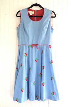 "This is a darling novelty, cherry theme embroidered dress.  It has never been worn and is in very good to excellent vintage conditon. Marked vintage size 14 Estimated size 12 38\" bust 32\" waist full hip 16\" shoulder to waist 40\" shoulder to hem  Purveyor's Note: We have searched far and wide, wrestled bears, braved the cold, traversed mountain ranges, fought pirates, swam with sharks and eaten at many a questionable road side taco stand to provide our customers with one of a kind vintage pieces.  Know that whichever piece you choose to make your own has its own story and has traveled through time to get to you.  Though we strive to provide the absolute best, \"pristine\" vintage pieces are rare birds, if not altogether non-existent.  That being said, please understand that part of buy Cherry Theme, Cherry Embroidery, Taco Stand, Mountain Ranges, Rare Birds, Vintage Pieces, Sharks, Embroidered Dress, Dress Clothes For Women