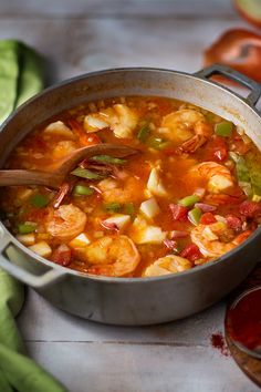 a pot filled with shrimp and vegetable soup