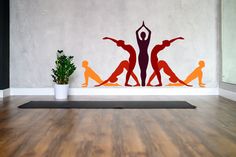 there is a yoga mat in front of a wall with the silhouettes of people doing yoga