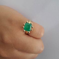 Emerald Ring with dots. Materials:18k Yellow Gold Emerald: 8x4 mmWidth: 8 mm. Each ring is custom made. It takes 20 days to make and ship. We will keep you updated via email. Available in sizes: 4,4 1/2, 5, 5 1/2, 6, 6 1/2, 7, 7 1/2, 8. Each emerald is unique. Handmade 14k Gold Emerald Ring For Anniversary, Handmade 14k Gold Rings For May Birthstone, Handmade 14k Gold Emerald Promise Ring, Handmade 14k Gold Emerald Ring For Promise, Elegant Handmade 14k Gold Emerald Ring, Handmade Classic Emerald Rings, Classic Handmade Emerald Promise Ring, Handmade Classic Emerald Promise Ring, Modern Handmade 14k Gold Rings