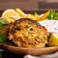 crab cakes on a plate with lemon wedges