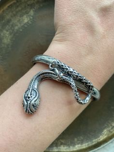 This vintage sterling silver snake bracelet is so unique and stunning. You have the option to wear it relaxed or clicked together. When clicked together, it measures 7.5 inches long. Silver Snake-shaped Bracelet As Gift, Silver Metal Snake Bracelet, Silver Snake-shaped Bracelet For Gift, Silver Metal Snake Bracelets, Silver Snake-shaped Bracelets For Gifts, Silver Snake Shape Bracelet As Gift, Silver Snake Bracelet As Gift, Silver Snake Bracelet Gift, Silver Snake Bracelet For Gift