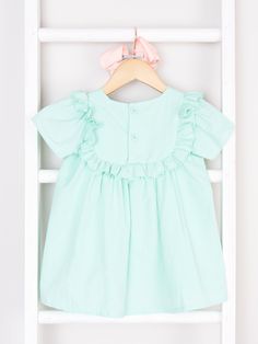 Have a twinning outfit moment with this stylish Mint Ruffle Dress. The paper bag material is a pleasure to wear, adding a playfully chic vibe to your look. Fits true to size. 100% Cotton. Accessories sold separately. Suggest bow color #56. Import. **Afterpay and Sezzle Purchase Requires $35 Minimum Order. Casual Cotton Dress With Ruffled Collar, Spring School Cotton Dresses, Spring Cotton School Dress, Casual Ruffle Sleeve Dress For Playdate, Spring Dress With Ruffled Collar For Dress-up, Green Cotton Dress With Ruffle Hem, Cute Spring Dress With Ruffled Collar, Cute Spring Dresses With Ruffled Collar, Casual Ruffled Dresses For School