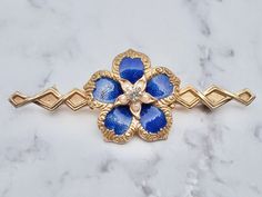 **conversions available, just ask :)  Vintage gold tone, enamel, rhinestone, and faux pearl flower brooch Weight - 8.5 grams Width -  63mm Good vintage condition; surface wear  follow me on Instagram for special deals ;) @mindilynjewelry Gold Enamel Wedding Brooch, Gold Enamel Wedding Brooches, Gold Enamel Costume Jewelry Brooches, Vintage Gold Enamel Pin For Wedding, Gold Vintage Enamel Pin For Wedding, Special Deals, Pearl Flower, Flower Brooch, Vintage Gold