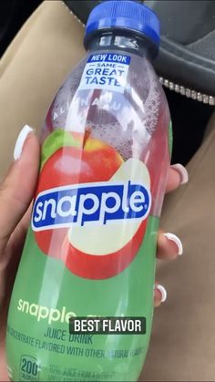 a hand holding a bottle of snapple apple flavored water in it's packaging