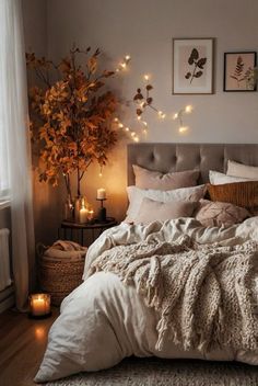 a bed with blankets, pillows and lights in a bedroom