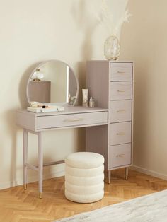 a vanity with a mirror and stool in a room