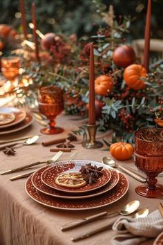 the table is set with candles, plates and utensils for an elegant thanksgiving dinner