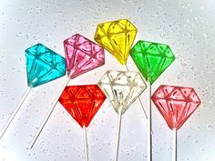 four different colored diamond shaped lollipops sitting on top of each other