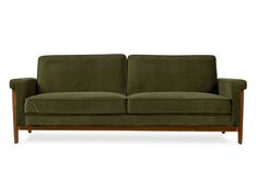 a green couch sitting on top of a wooden frame