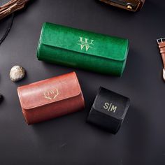 three different types of personalized leather cases on a black surface with other items around them