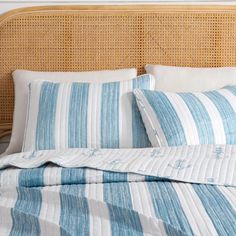 a bed with blue and white striped sheets