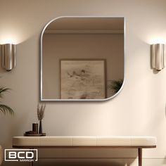 a mirror is hanging on the wall above a table with a plant and potted plants