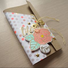 an open gift bag with some decorations on it