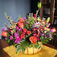 a basket filled with lots of colorful flowers