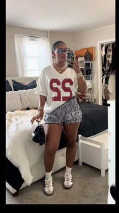 College Jersey Outfit, Plaid Shorts Outfit Black Women, College Game Day Outfit Black Women, Shorts And Sambas, Baddie Game Day Outfit, Jersey Shorts Outfit Women, Jersey Shorts Outfit, Checkered Outfit Women, Checkered Shorts Outfit