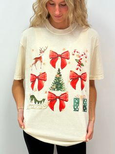 Get ready for the holidays with our best selling Watercolor Coquette Christmas tee! With its sleek design and comfortable fit, this shirt is perfect for anyone who wants to add a little Christmas whimsy to their closet for the season!  100% pre-shrunk cotton!  Professionally direct to garment printed on ivory Comfort Colors apparel. No transfers and no vinyl means no cracking! :)  Tees are true to size for a relaxed, slightly boxy unisex fit. We recommend laundering inside out to prevent prematu Casual Festive Tops For Christmas, Casual Short Sleeve Tops For Festive Occasion, Holiday Graphic Tee, Cute Cotton Holiday Tops, Cotton Tops For Holiday Season, Cute White Christmas Tops, Cute Holiday Graphic Print Tops, Cute White Top For Festive Occasions, Festive White Holiday Top