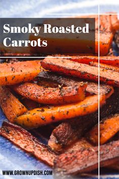 some roasted carrots are on a blue plate with the words smoky roasted carrots