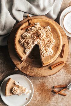 there is a piece of cake on the plate and some cinnamon sticks next to it