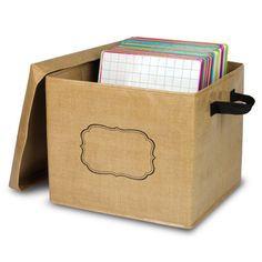 a cardboard box filled with lots of notes and folders on top of a white background