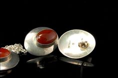 "These are 2 beautiful and unique MODERN CARNELIAN STERLING SILVER c. 1960 earrings and necklace set (13.8g) The wonderful set has Modern styl, fantastic shape with sterling and carnelian. The set have a very idyllic, exotic and elegant feel to it. The necklace measures 1 1/4\" x 3/4\" pendant, 17\" long chain and earrings 1\" x 3/4\". The 2 piece are in very good condition. 0.7 Aojhpc-802-136" Handmade Mid-century Jewelry Gift, Mid-century Red Jewelry For Gift, Mid-century Round Jewelry Gift, Mid-century Polished Finish Jewelry For Anniversary, Vintage Carnelian Jewelry With Polished Finish, Vintage Polished Carnelian Jewelry, Elegant Carnelian Jewelry Stamped 925, Formal Silver Carnelian Jewelry, Mid-century Sterling Silver Jewelry In Silver