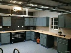 an empty garage with lots of cabinets and tools