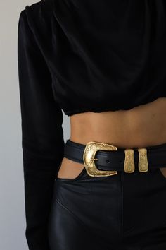 Add a vintage touch to your look with this western-inspired belt featured in black Italian leather, an eye-catching gold buckle, engraved details, and a metal tip. Feather Edge Adjustable Fit 1.5" Genuine Italian Leather Ethically Made in California Gold Western Belt, Big Buckle Belt, Gold Buckle Belt, Dinner Party Outfits, Statement Belt, Gold Belt, Order Book, Safety Belt, Black Leather Belt