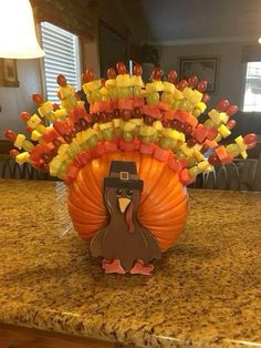 a turkey made out of candy sitting on top of a counter next to a lamp