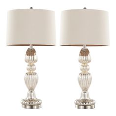 two clear glass table lamps with white shades on each lamp, one is turned off and the other has a beige shade