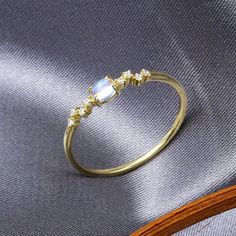 Holiday Notice: We will be on holiday from Feb 6 to Feb 15 for the Spring Festival. Orders will be shipped after we resume work.  Simple Moonstone Promise Ring, Minimal Moonstone Ring, Moonstone Engagement Ring, Yellow Gold Moonstone Ring, Moonstone Solitaire Ring, GiftFeatures• Made to Order. • Material: 925 Silver with Gold Plated• Gold Color: Yellow Gold• Stone Type: Natural Blue Moonstone• For the material option sterling silver, it means it’s made in sterling silver with gold plated on surf Dainty Moonstone Open Crystal Ring, Dainty Moonstone Open Ring, Dainty Open Moonstone Ring, Moon-shaped Moonstone Promise Ring, Moon Shaped Moonstone Promise Ring, Minimalist Moonstone Ring In Moon Shape, Dainty Moonstone Moon-shaped Rings, Gold Moonstone Ring, Engagement Ring Yellow Gold