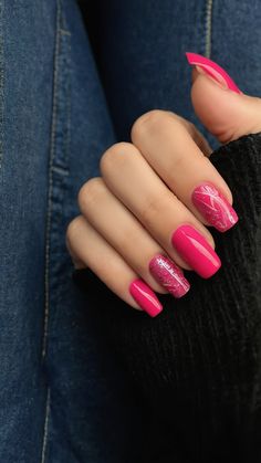 a woman's hand with pink and white nail polish on her nails, sitting in jeans