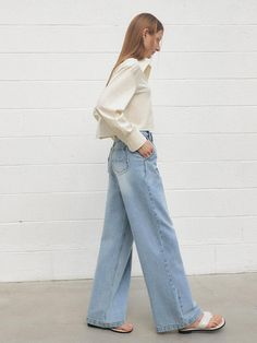 This product features a pair of one-tuck wide Dolingo denim pants that marry comfort with a touch of retro flair. The wide-leg design and high waist create a flattering silhouette and a relaxed vibe. With their single tuck detail, these jeans provide a subtle nod to classic tailoring while remaining effortlessly modern. - The pants are tailored with a wide-leg design and a high waist, offering a vintage-inspired yet contemporary look.- A handmade Cali medal decoration has been attached to the lower right side of the front panel to add a unique point of interest.- The one tuck at the front adds structure and style to the otherwise fluid design.- Constructed from denim, these pants are durable and versatile, ideal for various casual and semi-casual settings. Chic Light Wash Relaxed Fit Flare Jeans, Chic Relaxed Fit Light Wash Flare Jeans, Chic Light Wash Pants For Fall, Chic Wide Leg Pants In Denim Blue For Fall, Retro Relaxed Fit Wide Leg Bottoms, Light Wash Wide Leg Flare Jeans For Work, Chic Denim Blue Wide-leg Flare Jeans, Retro Wide Leg Bottoms With Relaxed Fit, Wide Leg Light Wash Flare Jeans For Work