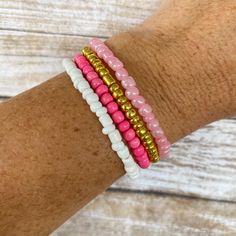 ♥ This pink seed bead stack bracelet set will level up your style and make your outfit pop! Wear one as a statement piece or the whole stack! These are so trendy right now! ♥ These are perfect for: ~ Stacking with other bracelets ~ Gifts for all ages ~ Party Favors or Stocking Stuffers ~ Beachwear/Pool wear ♥ This listing includes the set of 4 bracelets shown. You can choose between the gold set, or the silver set in the drop-down menu. To purchase multiple sets, adjust the quantity at checkout. These beaded bracelets are made with 6/0 seed beads. They are strung together with elastic which is stretchy.  ♥ CUSTOMIZATION: These are customizable! Just send us a message about what colors or theme you would like, and we will discuss customization options. Otherwise, bracelets will come as show Casual Pink Friendship Bracelet With Tiny Beads, Casual Pink Friendship Bracelets With Tiny Beads, Pink Stackable Friendship Bracelets For Beach, Pink Heishi Beads Beaded Bracelets, Casual Pink Stretch Bracelet With Tiny Beads, Casual Pink Stackable Beaded Bracelets, Stackable Pink Beaded Bracelets With Round Beads, Pink Stackable Heishi Beads Bracelets, Stackable Pink Beaded Bracelets