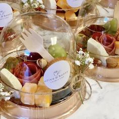 a table topped with lots of glass bowls filled with different types of foods and desserts